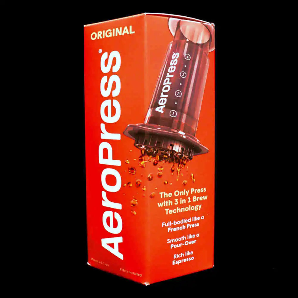 Red Aeropress coffee maker packaging with product image and branding on a black background