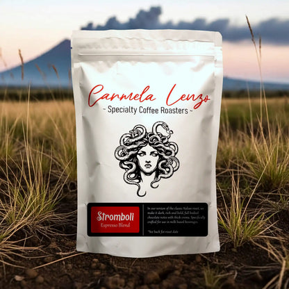 Carmela Lenzo coffee bag with a scenic background of grass and mountains.