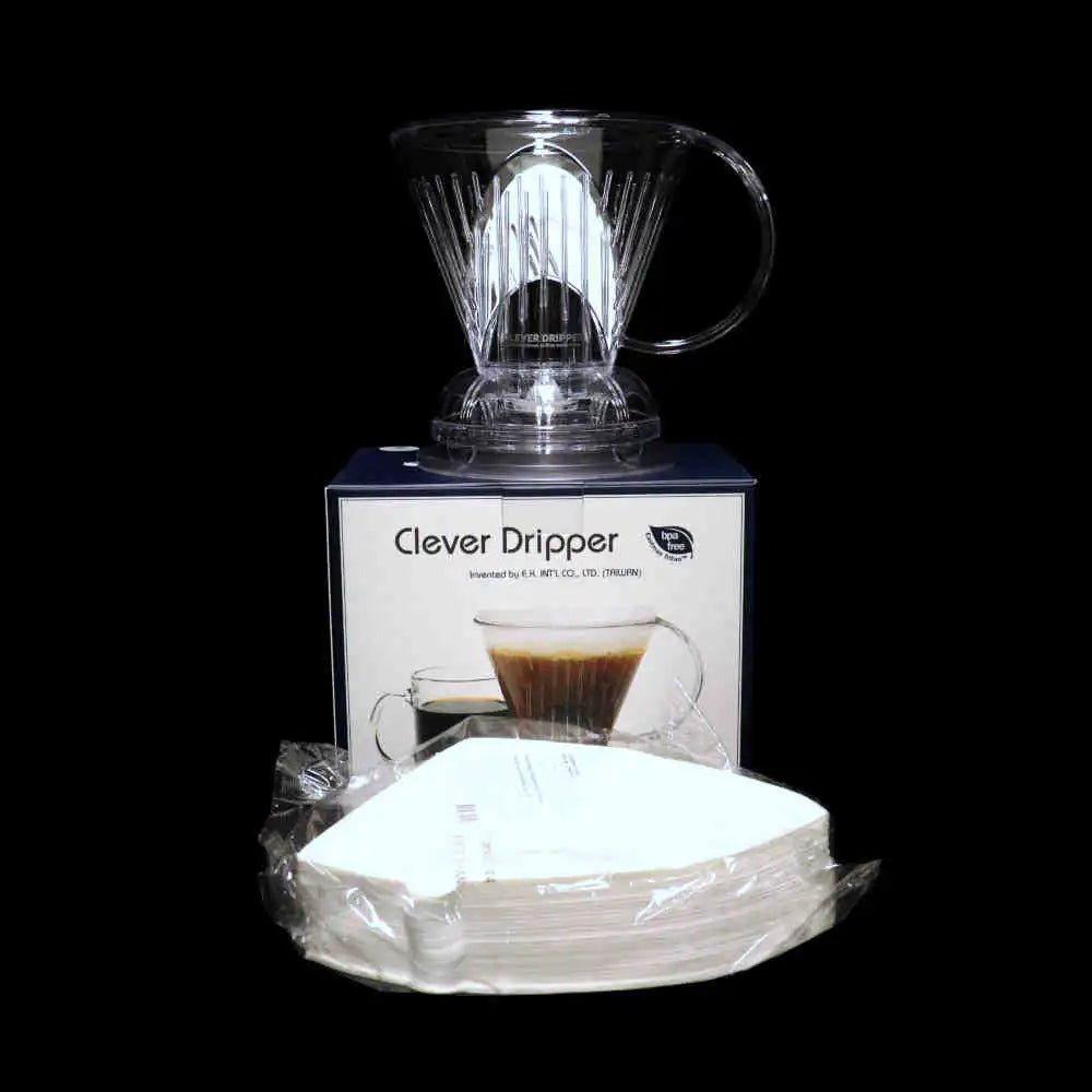 Clever Dripper with packaging and coffee filters on a black background