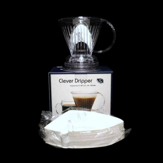 Clever Dripper with packaging and coffee filters on a black background